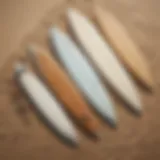 Different types of surfboards displayed on a sandy beach