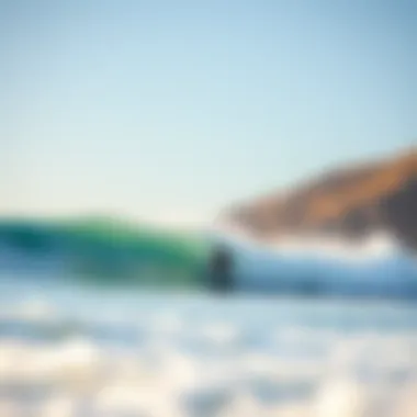 Surfer catching a wave at a popular surf spot in Big Sur