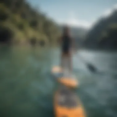 A beginner paddler on a perfectly sized paddle board in calm waters.