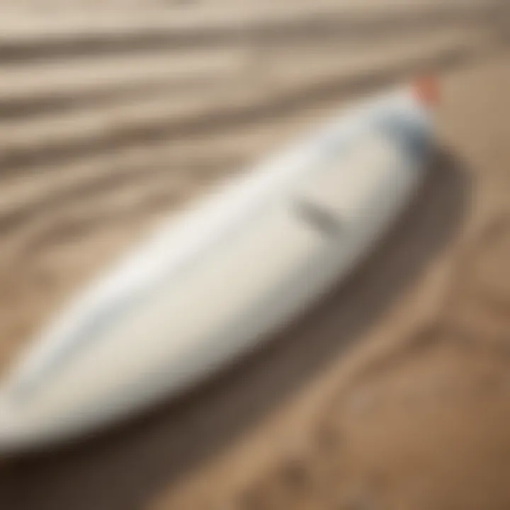 Close-up of a surfboard resting on the sand