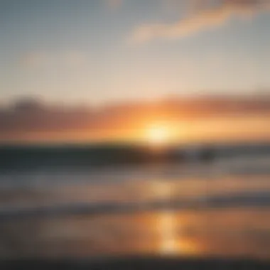 A serene view of surfers catching waves at sunset