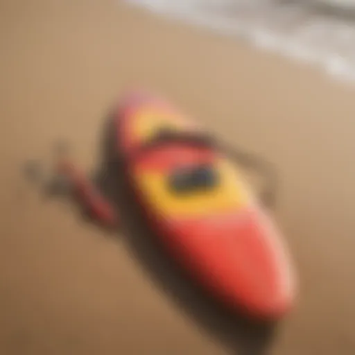 A vibrant surfboard with paddle gear resting on a sandy beach, illustrating the essentials of paddle competition.