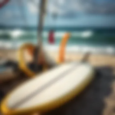 Close-up of surfboard and sailing gear on the beach