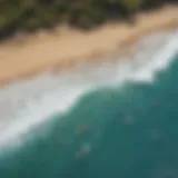 Aerial view of Waimea Bay showcasing surfers riding powerful waves under a clear blue sky.