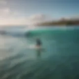 A stunning view of Aruba's coastline with surfers riding the waves