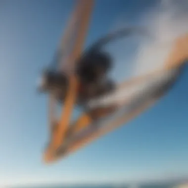 Close-up of a kitesurfing board and kite against a blue sky