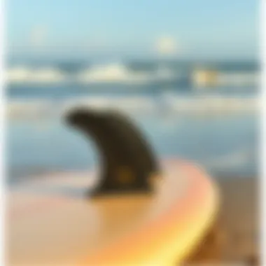 Close-up of surfboard with fins on the beach