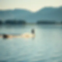 A serene lake with a surfer riding a wake created by a boat, showcasing the beauty of inland surfing.