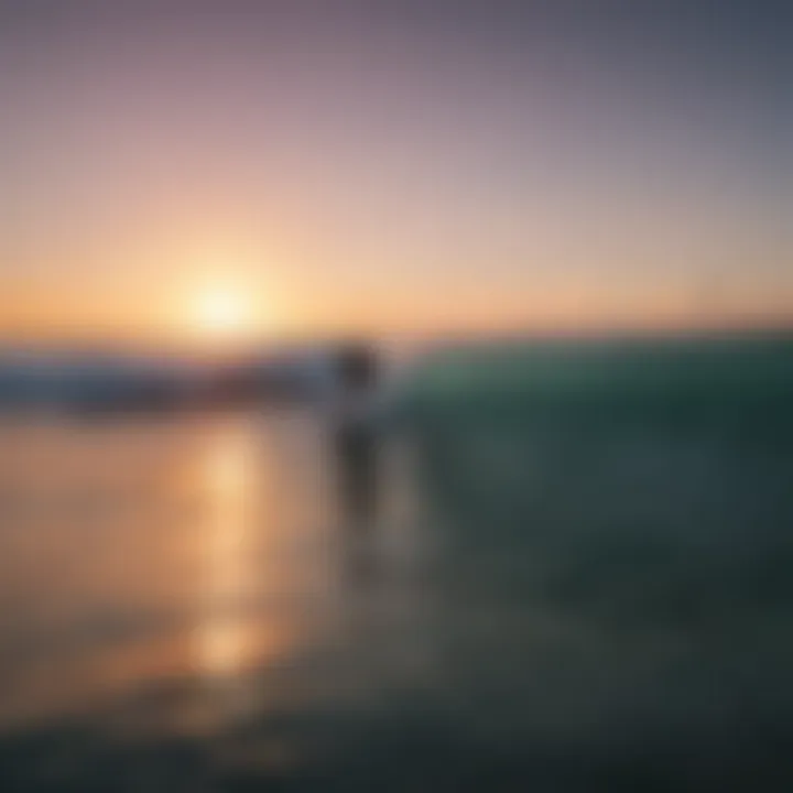 Surfers riding waves at sunset