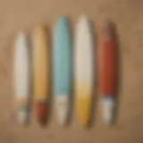 Different types of surfboards displayed on a sandy beach