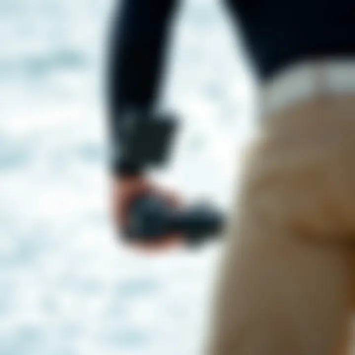 Surfer reviewing camera settings before hitting the waves