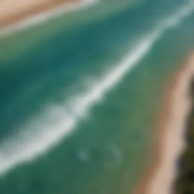 An aerial shot of surfers catching waves in the turquoise waters of South Padre Island