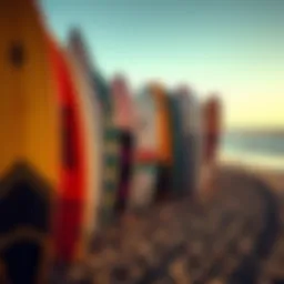 A close-up of surfboards lined up on a beach