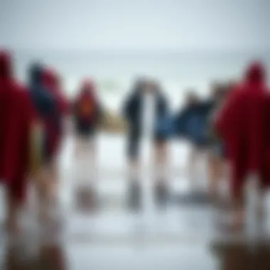 Surfers Gathered in Towelling Ponchos on the Beach Group of surfers wearing towelling ponchos on the beach