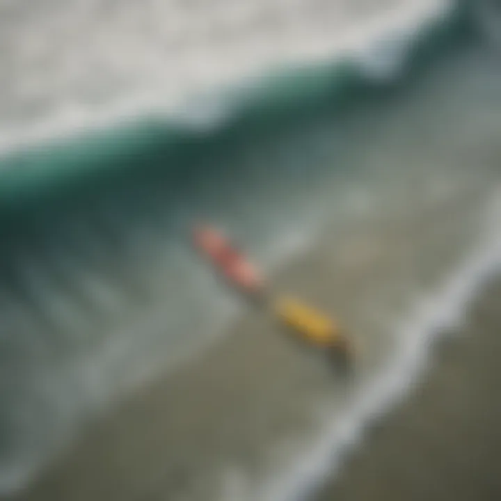 Aerial view of surfers riding waves in a saline ocean