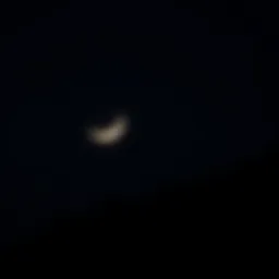 The waxing crescent moon illuminating a serene night sky