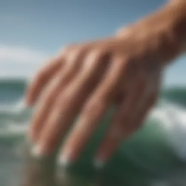 Surfer demonstrating wrinkled fingertips after a long surf session.